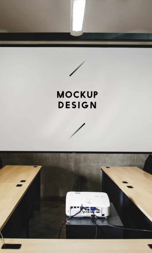 Blank white projector screen mockup in a meeting room